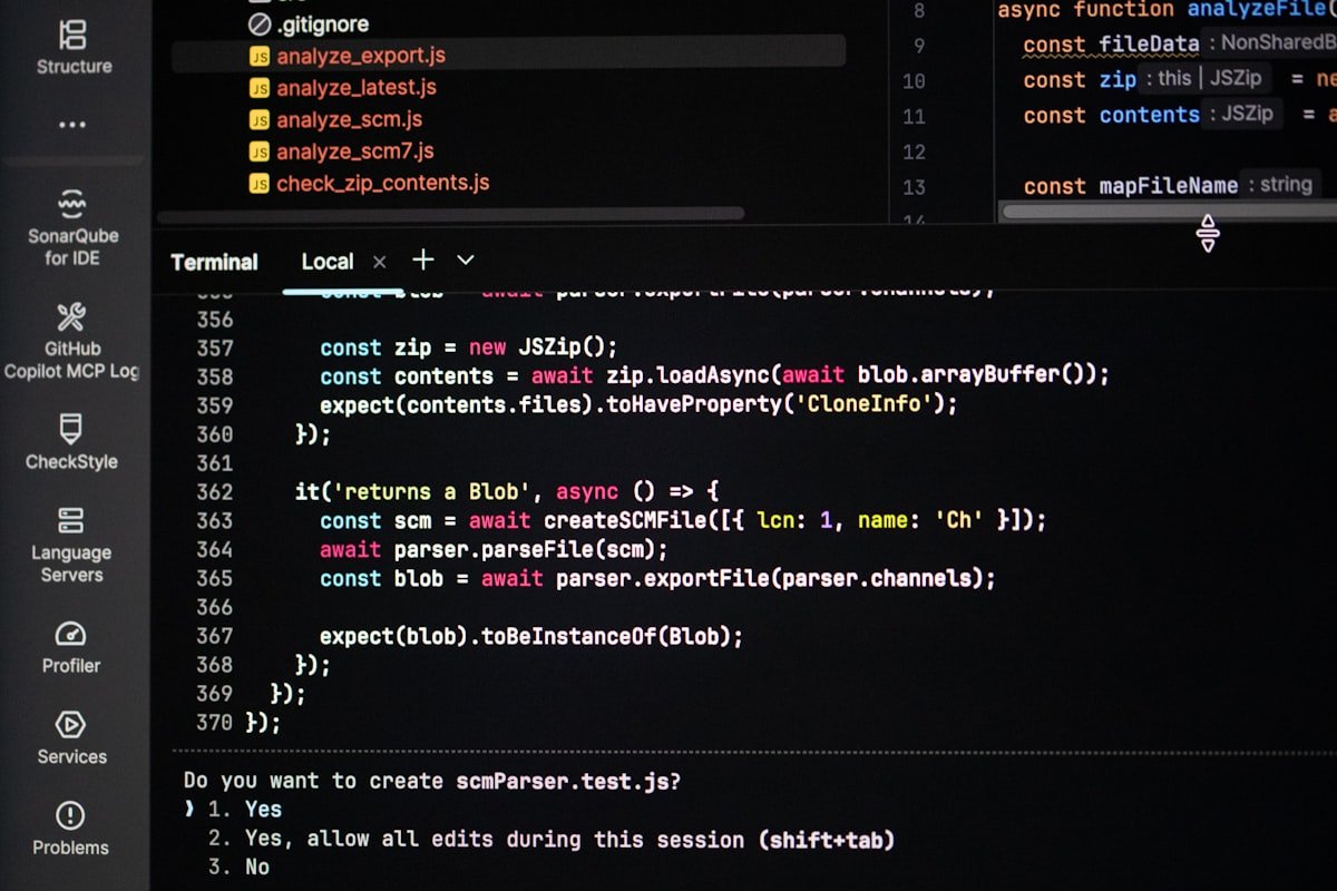 Developer writing code for a custom web application on a laptop