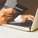 Customer making a secure online purchase with a card on a laptop