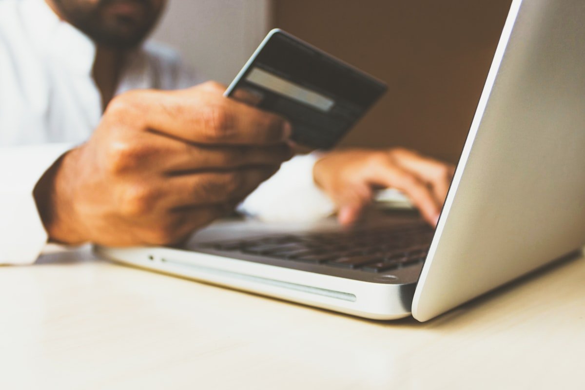 Customer making a secure online purchase with a card on a laptop